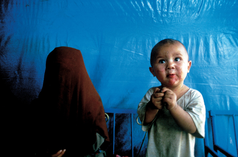 蒙着面纱的妇女和正在吃羊肉串的小孩，新疆喀什